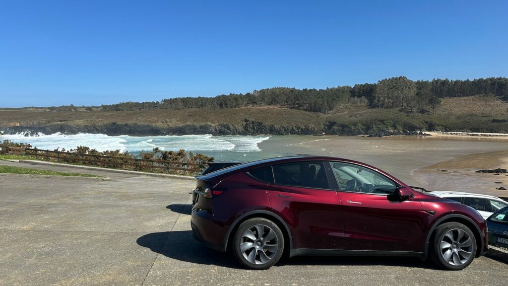 Mi Tesla rojo de perfil junto a una playa, con los neumáticos Hankook Ventus S1 evo3 EV montados